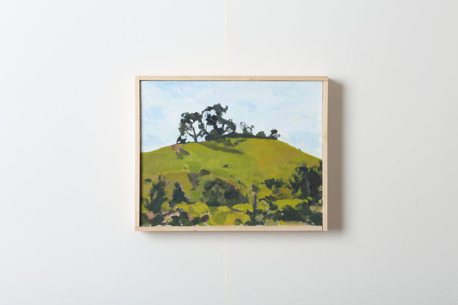 Framed painting of a green landscape with trees