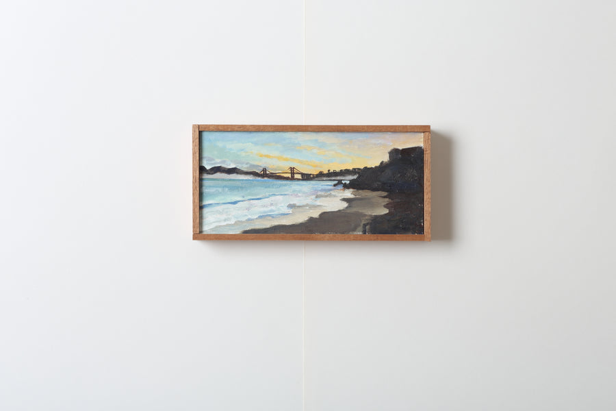 Framed painting of a beach scene with the Golden Gate Bridge in background