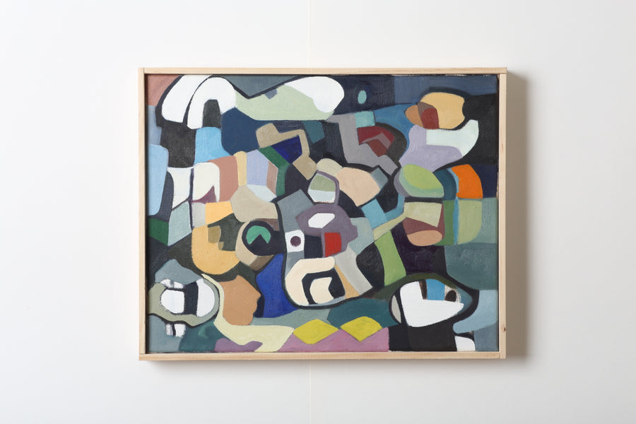 Abstract painting with a multi-colored design in a wooden frame on a white wall