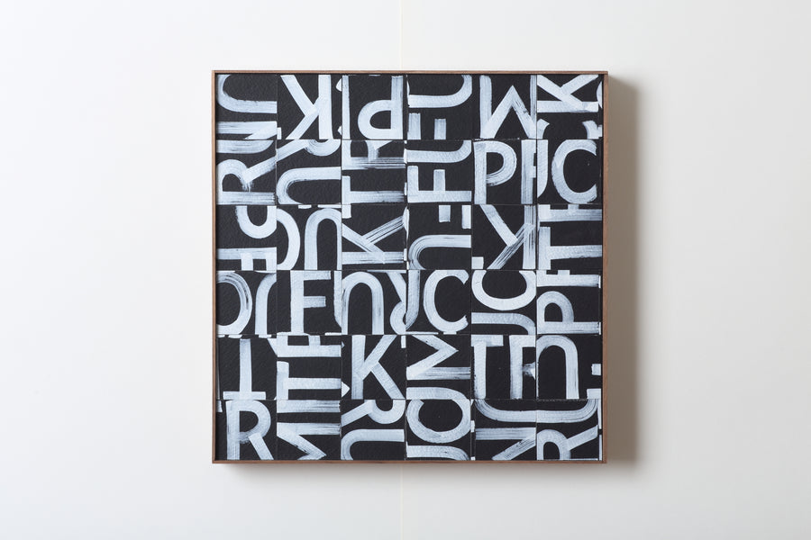 Scrambled white lettering on a black background revealing a hidden message.  