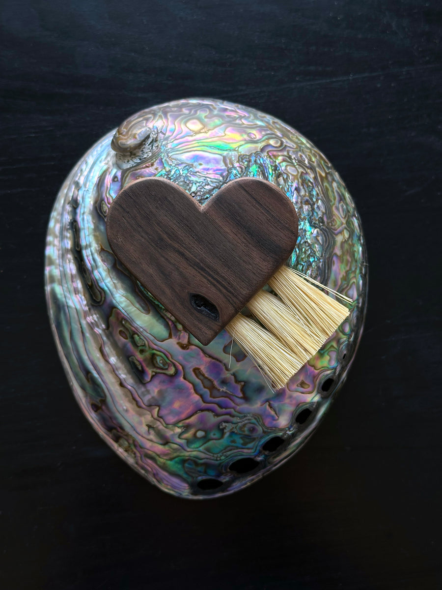 Erin Irber Heart Brush on top of a abalone shell